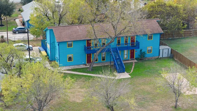 a house view with swimming pool in front of it