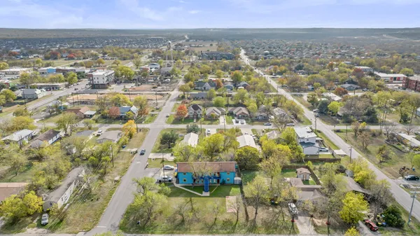 a view of a house with a yard and a fountain