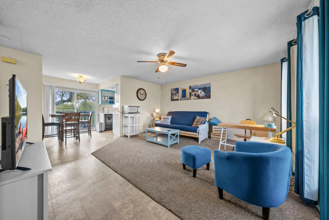 202 West Wheeler Street Manor, TX 78653 - Photo 26 of 28 a living room with furniture and a flat screen tv