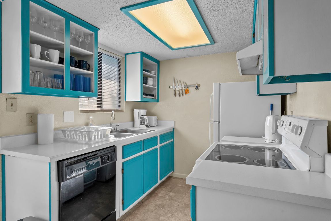 202 West Wheeler Street Manor, TX 78653 - Photo 6 of 28 a kitchen that has a sink and a stove