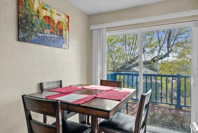 a living room with furniture a rug and a large window