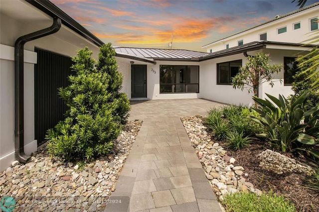 a view of a house with potted plants