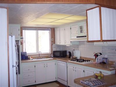 3000 Sacramento Road Phelan, CA 92371 - Photo 1 of 1 a kitchen with stainless steel appliances granite countertop a refrigerator sink and cabinets