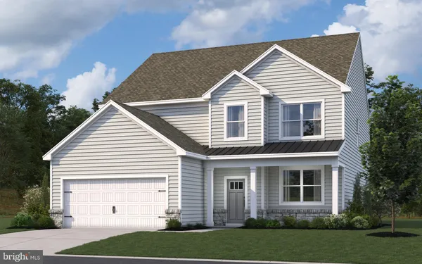 a view of a white house next to a yard and large trees