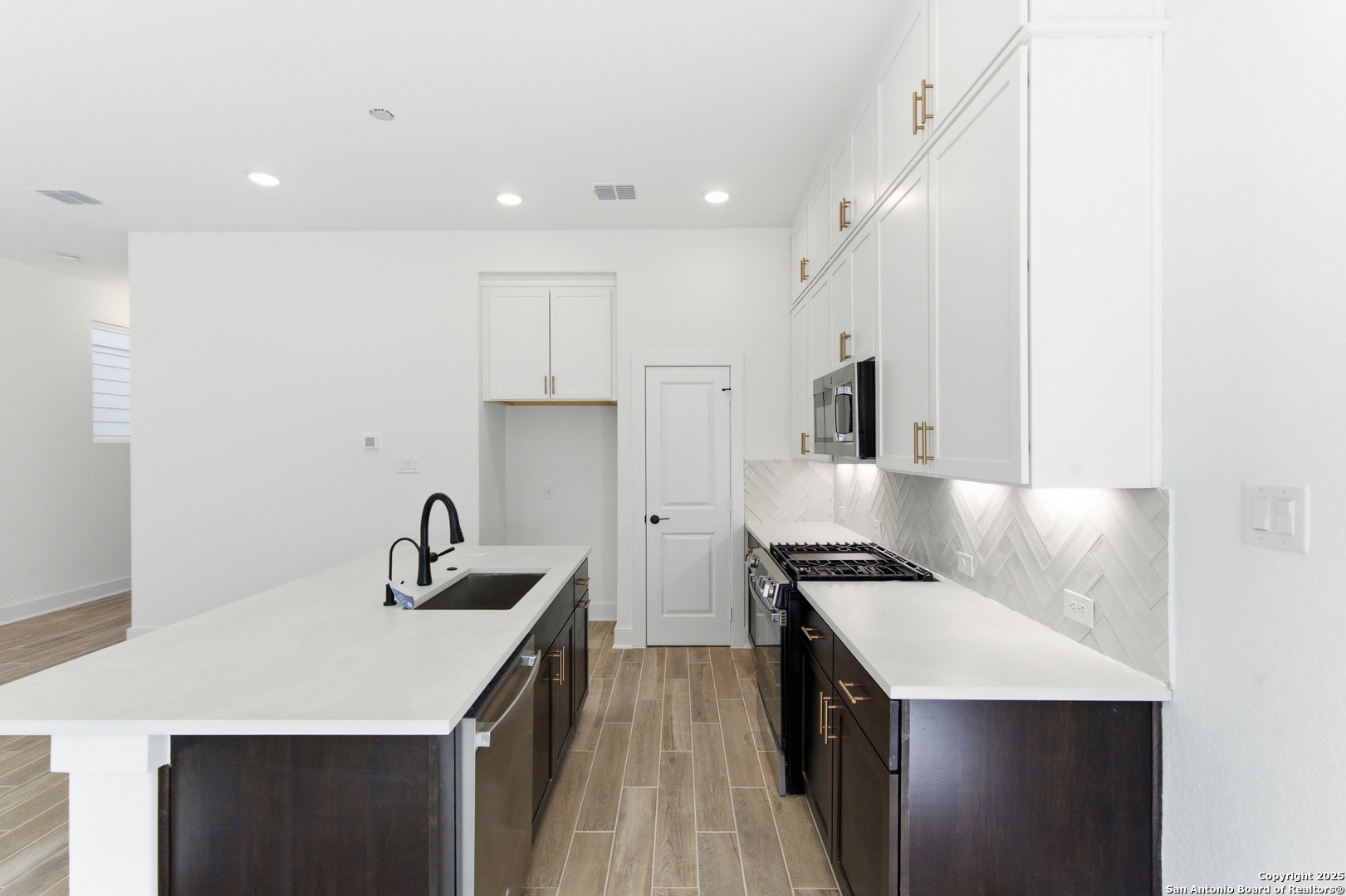 6464 Babcock Road, Unit 717 San Antonio, TX 78249 - Photo 18 of 44 a kitchen with a sink dishwasher a stove and a refrigerator with wooden floor