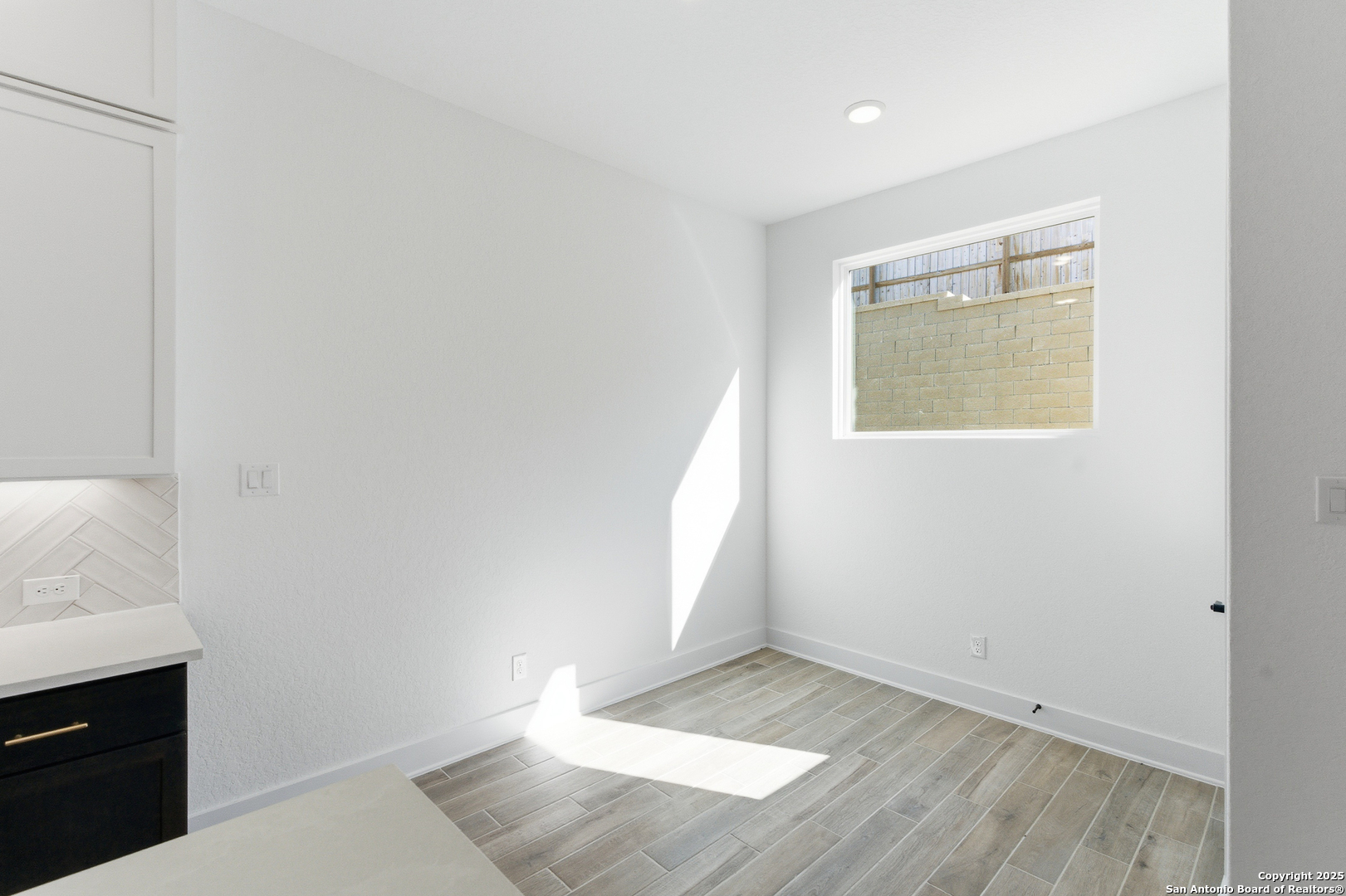 6464 Babcock Road, Unit 717 San Antonio, TX 78249 - Photo 20 of 44 an empty room with wooden floor and windows