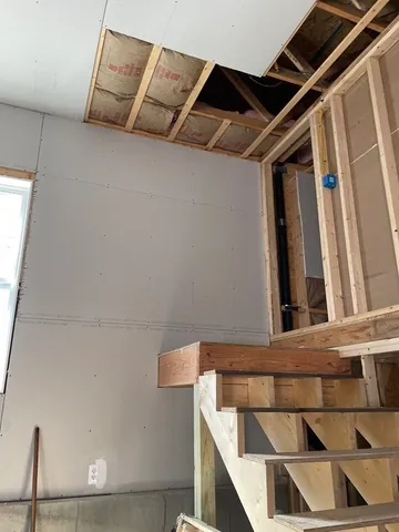 a view of a room with wooden floor and windows