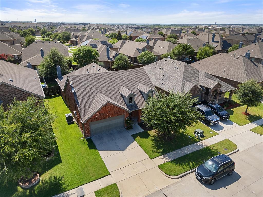 520 Rustic Oak Lane McKinney, TX 75072 - Photo 29 of 30 Brick facade residence with an attached garage, dormer windows, and a shingle roof