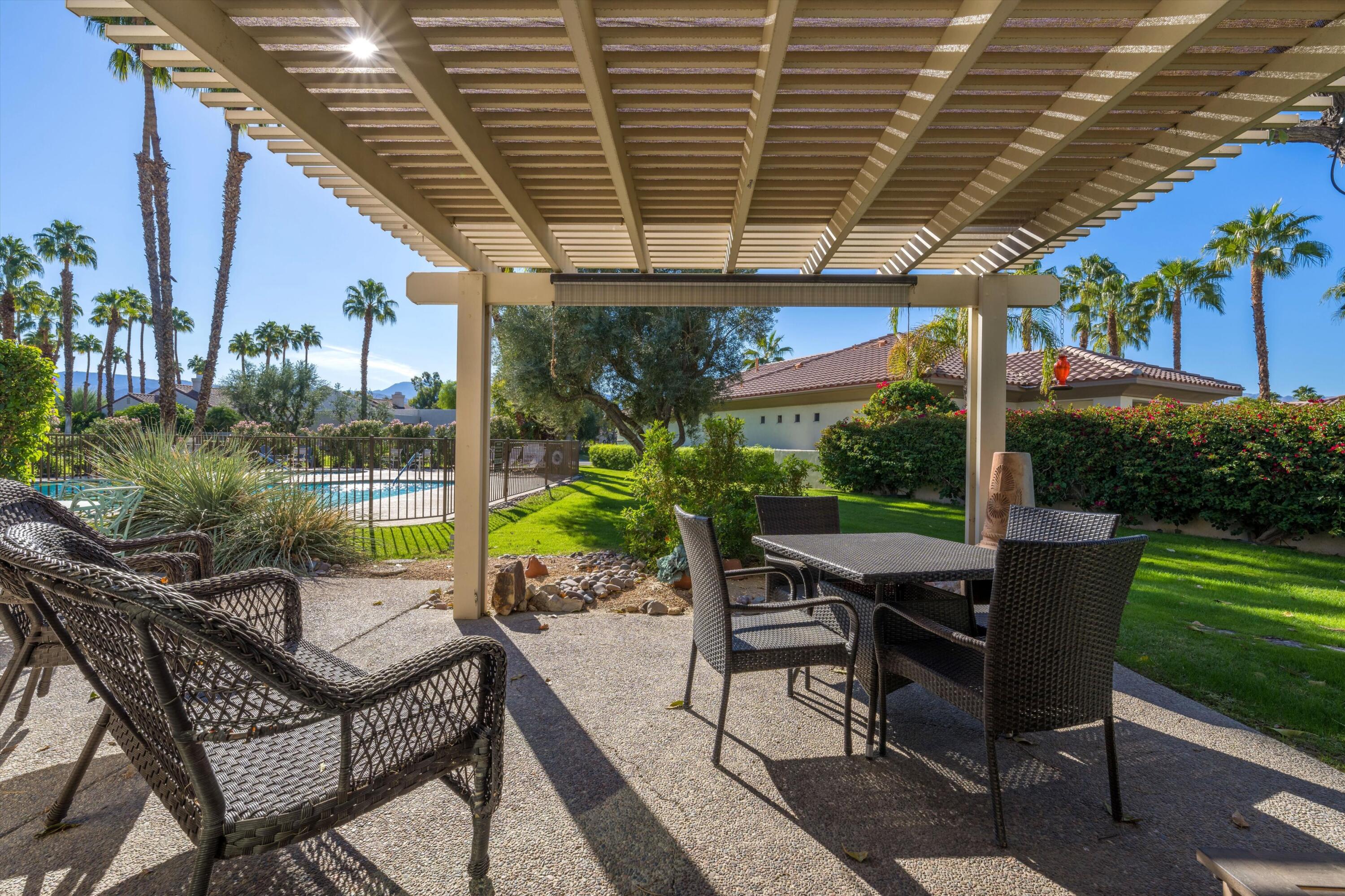 464 Sunningdale Drive Rancho Mirage, CA 92270 - Photo 12 of 47 a view of a patio with a table chairs and a backyard