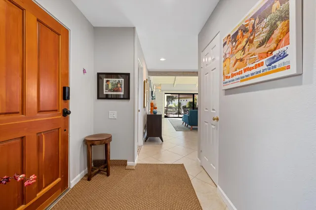 a view of a hallway with workspace and a window