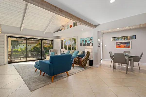 a living room with furniture and a floor to ceiling window