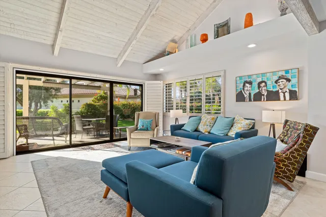 a living room with furniture and a large window with outer view