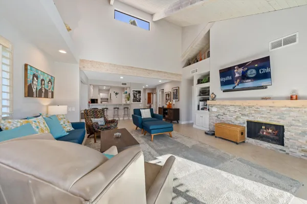 a living room with furniture and fireplace