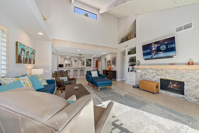 a living room with furniture and fireplace