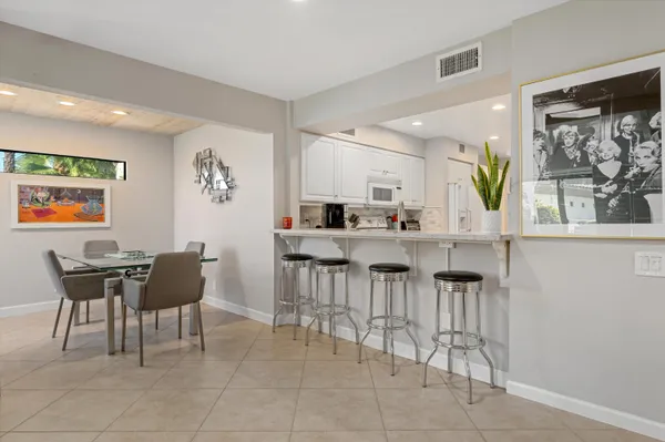 a dining room with furniture a window and kitchen view