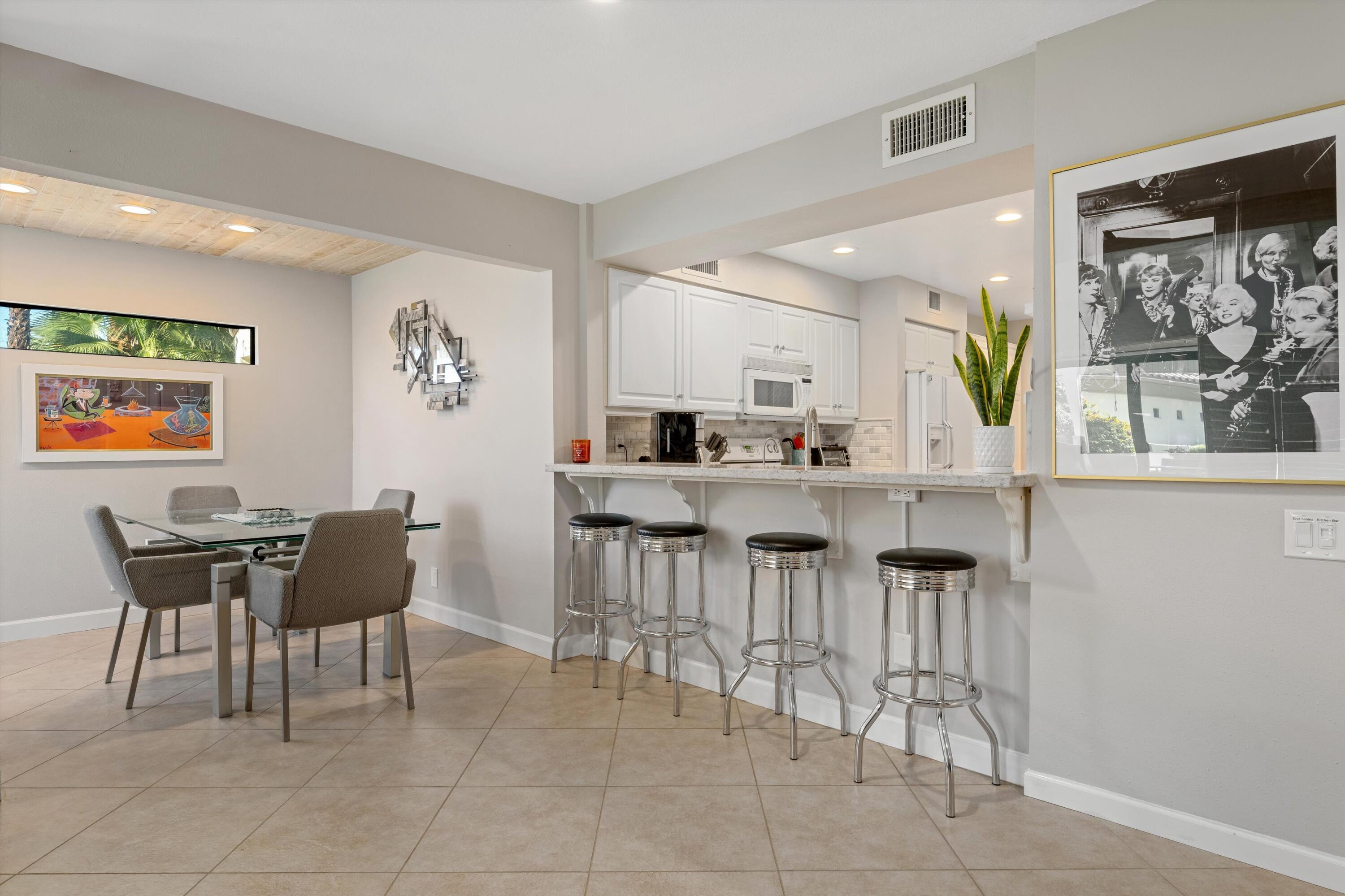 464 Sunningdale Drive Rancho Mirage, CA 92270 - Photo 29 of 47 a dining room with furniture a window and kitchen view
