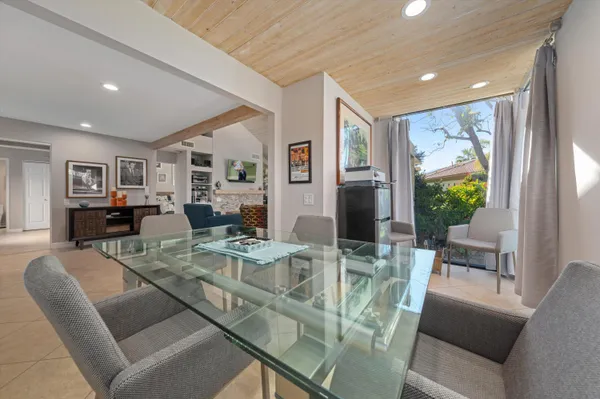 a view of a dining room with furniture large windows and wooden floor