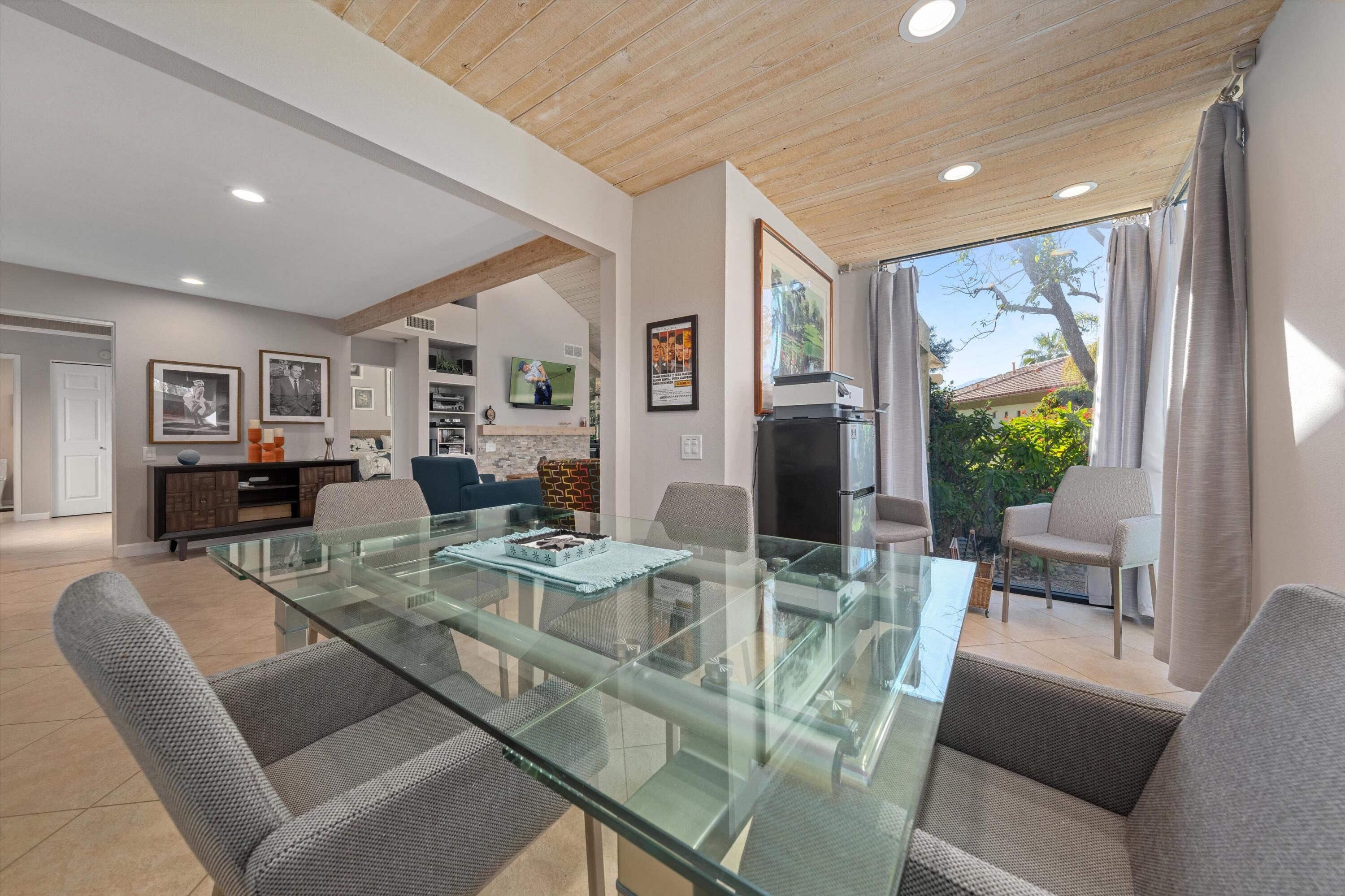 464 Sunningdale Drive Rancho Mirage, CA 92270 - Photo 31 of 47 a view of a dining room with furniture large windows and wooden floor