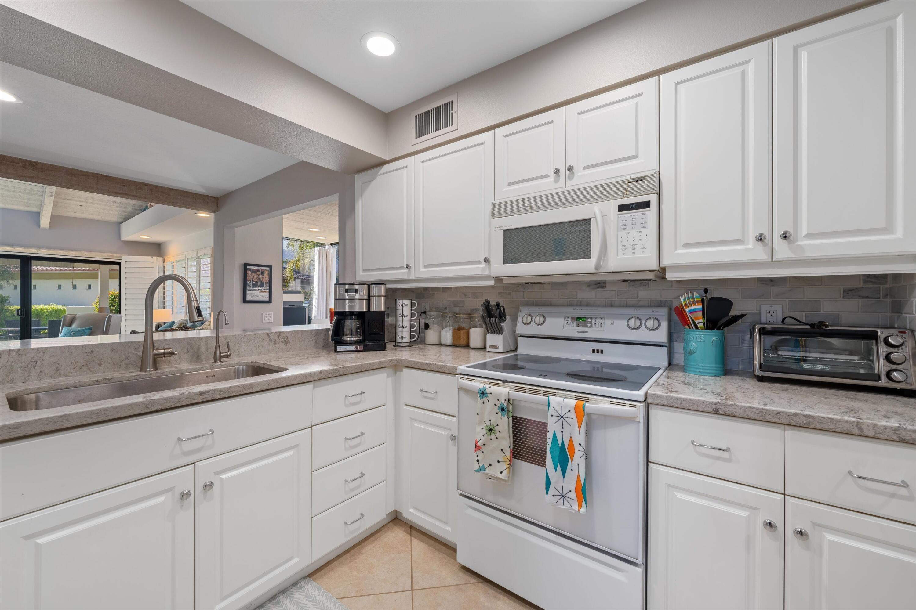 464 Sunningdale Drive Rancho Mirage, CA 92270 - Photo 32 of 47 a kitchen with appliances a sink and cabinets