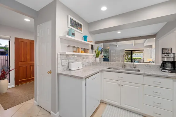 a kitchen with granite countertop cabinets and window