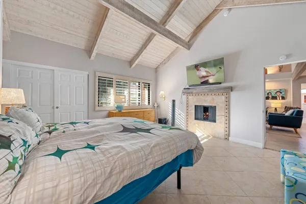 a bedroom with a bed and a fireplace