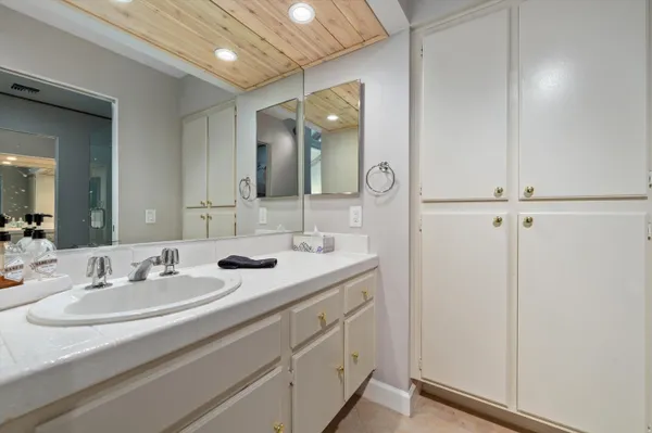 a bathroom with a double vanity sink and mirror