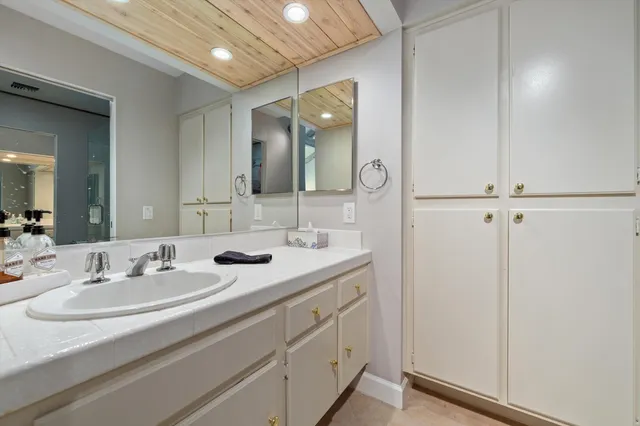 a bathroom with a double vanity sink and mirror