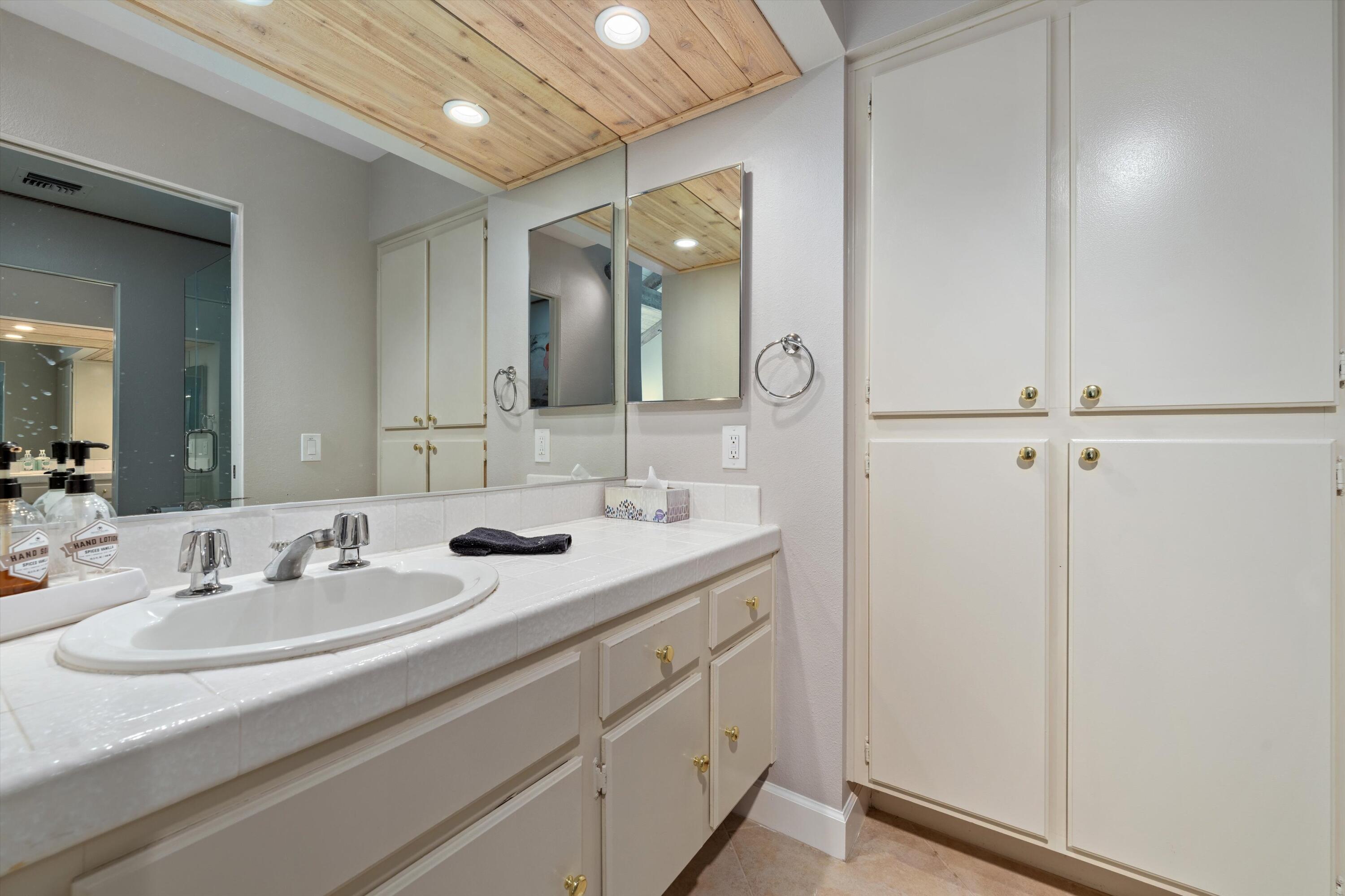 464 Sunningdale Drive Rancho Mirage, CA 92270 - Photo 38 of 47 a bathroom with a double vanity sink and mirror