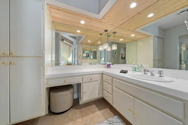 a spacious bathroom with a double vanity sink and a mirror
