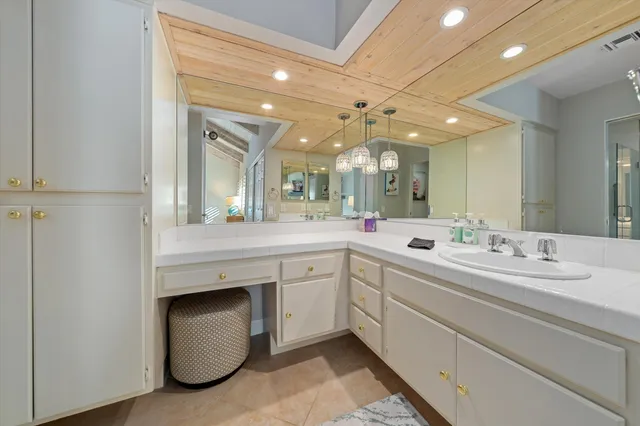 a spacious bathroom with a double vanity sink and a mirror