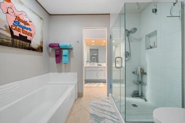 a bathroom with a tub and shower