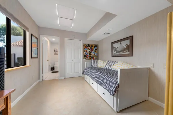 a view of a bedroom with furniture and windows