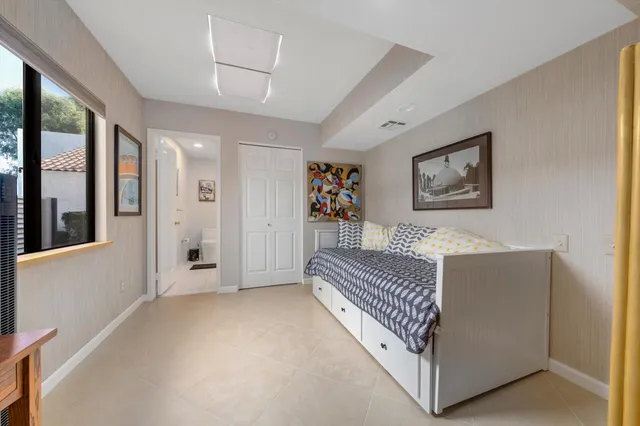 a view of a bedroom with furniture and windows