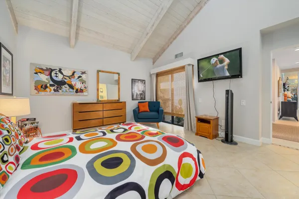 a bedroom that has a bed and a table in it