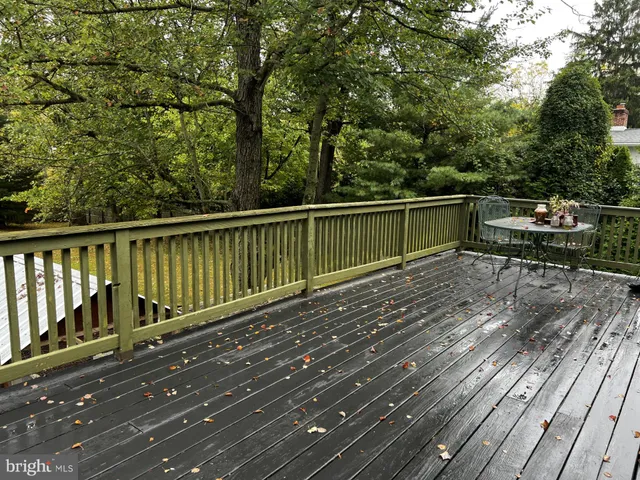 a view of balcony with wooden floor and outdoor seating