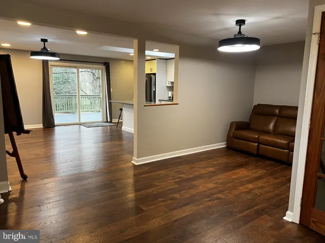 a view of livingroom with hardwood floor and a ceiling fan