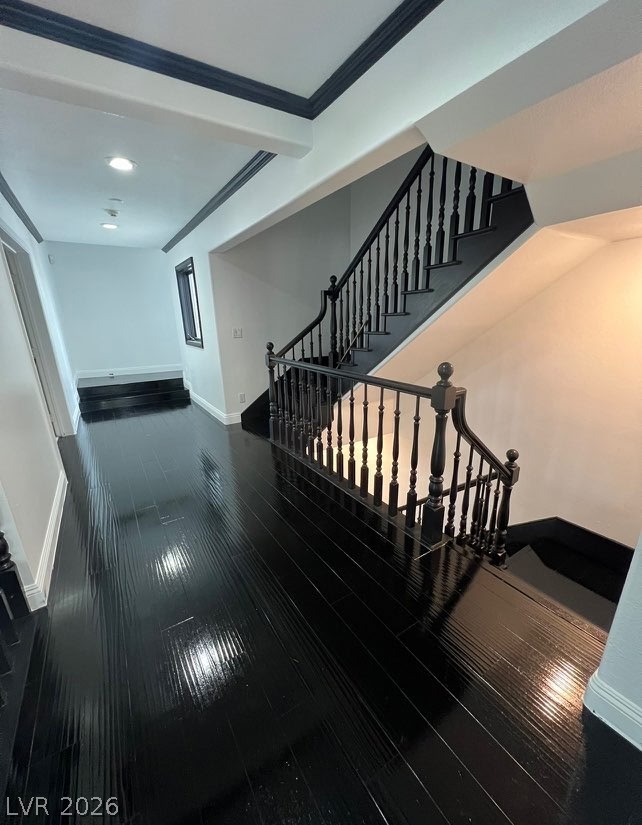 3003 Regency Hill Henderson, NV 89014 - Photo 10 of 13 A grand staircase with dark wood balusters gracefully ascends from a hallway with lustrous dark hardwood floors.
