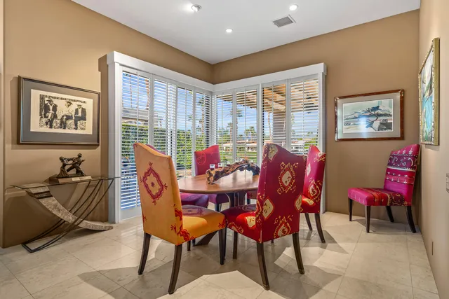a kitchen with stainless steel appliances kitchen island granite countertop a sink and a refrigerator