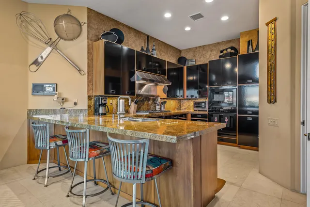 a large bathroom with a granite countertop tub sink and mirror