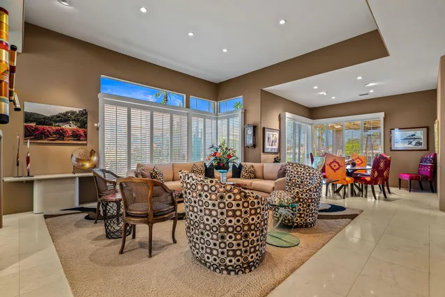 a living room with fireplace furniture and a large window