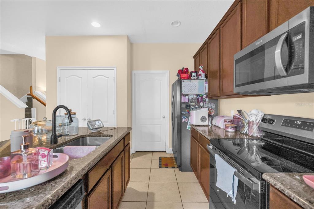 12353 Via Derna Place Windermere, FL 34786 - Photo 12 of 26 a kitchen with stainless steel appliances granite countertop a sink stove and cabinets