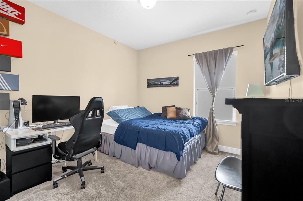 12353 Via Derna Place Windermere, FL 34786 - Photo 15 of 26 a bedroom with a bed and a computer on a desk