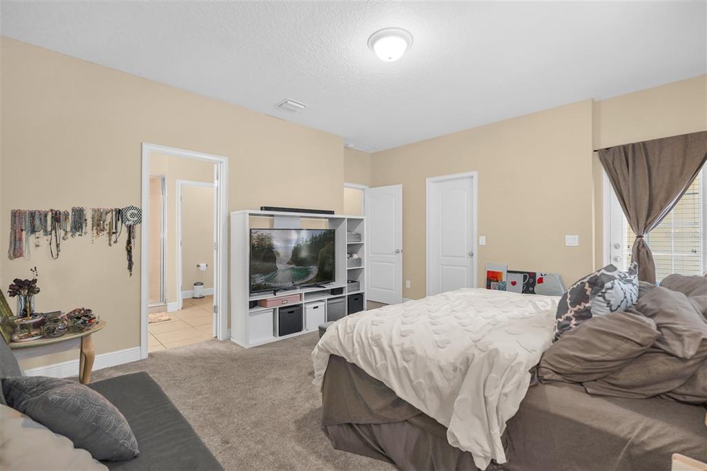 12353 Via Derna Place Windermere, FL 34786 - Photo 19 of 26 a bedroom with a bed and a flat screen tv