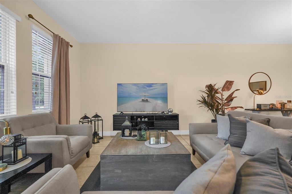 12353 Via Derna Place Windermere, FL 34786 - Photo 2 of 26 a living room with furniture and a potted plant