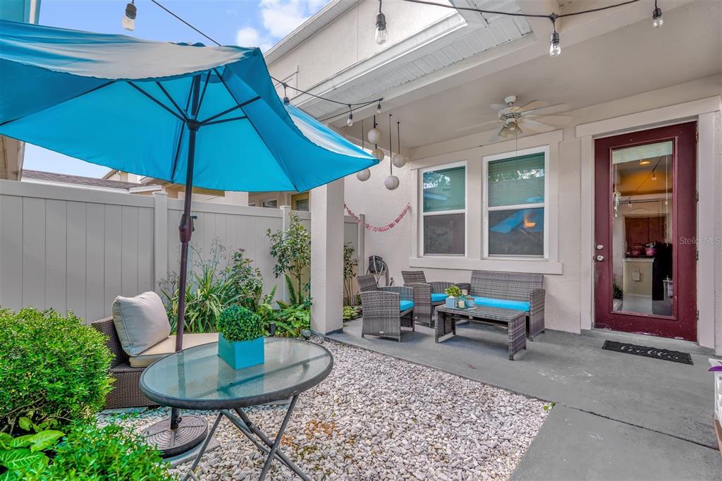 12353 Via Derna Place Windermere, FL 34786 - Photo 21 of 26 a view of a house with backyard sitting area and garden