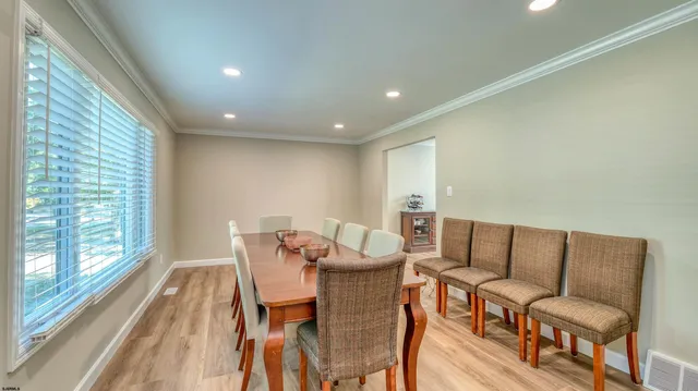 a dining room with furniture and wooden floor