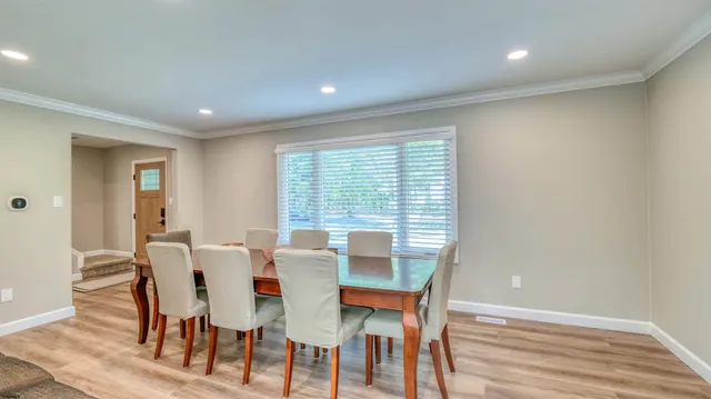 a dining room with furniture and wooden floor