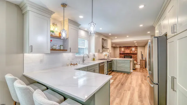 a kitchen with stainless steel appliances a stove a sink and a refrigerator