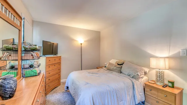 a bedroom with a bed and a dresser in it