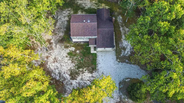 an aerial view of a house with a yard